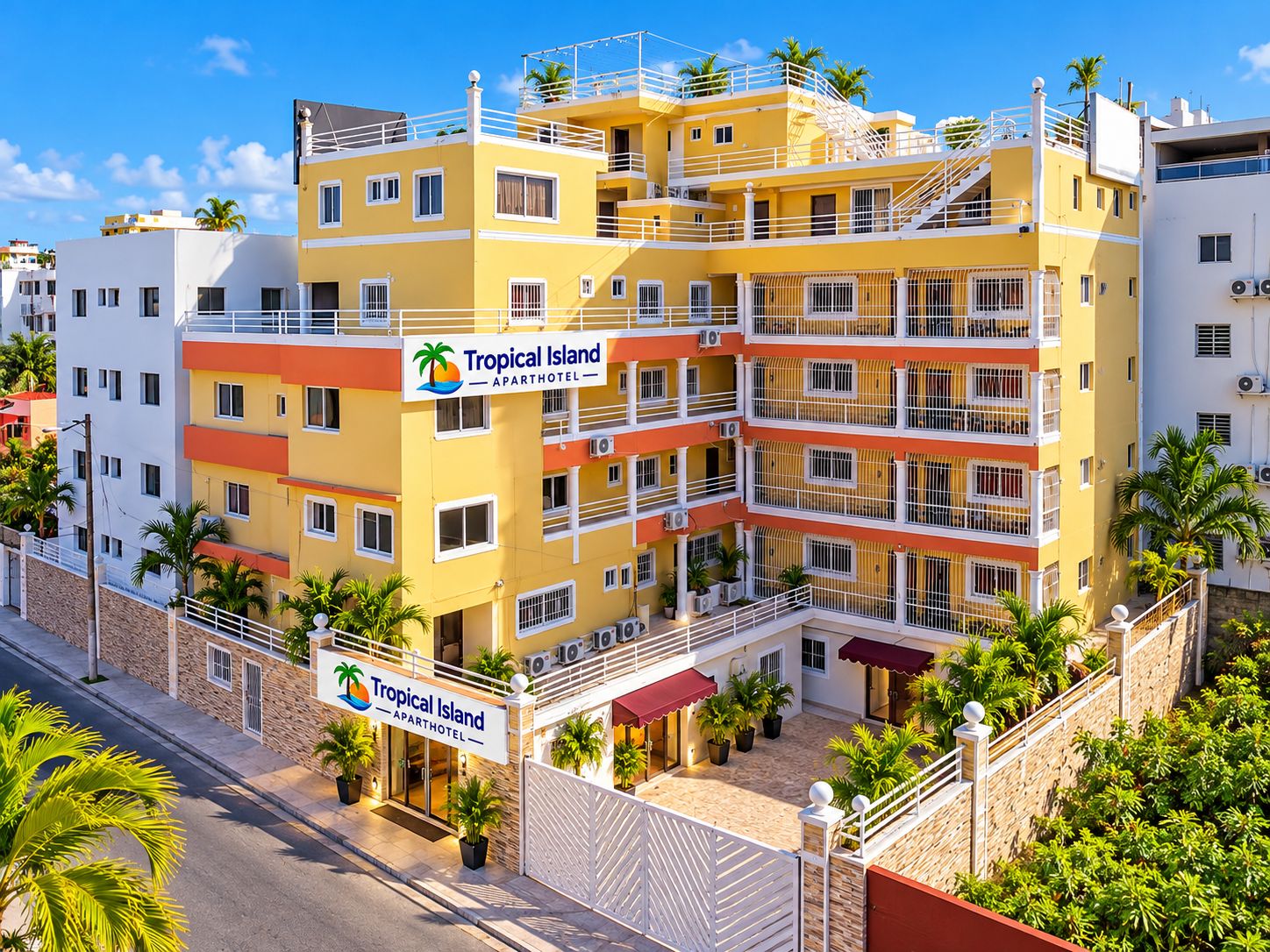 A multi-story building with balconies and a sign indicating it is an apartment hotel named Tropical Island.