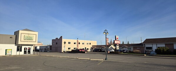A motel with a sign, a Family Foods store, and a parking lot.