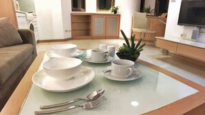 A dining area with a table set for four, including bowls, cups, and cutlery. - Cozy place in the hub of Taipei city (Taipei)
