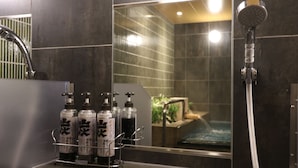 A bathroom with a shower, a mirror, and a shelf with bottles. - HOTEL J-SHIP OSAKA NAMBA (Osaka)
