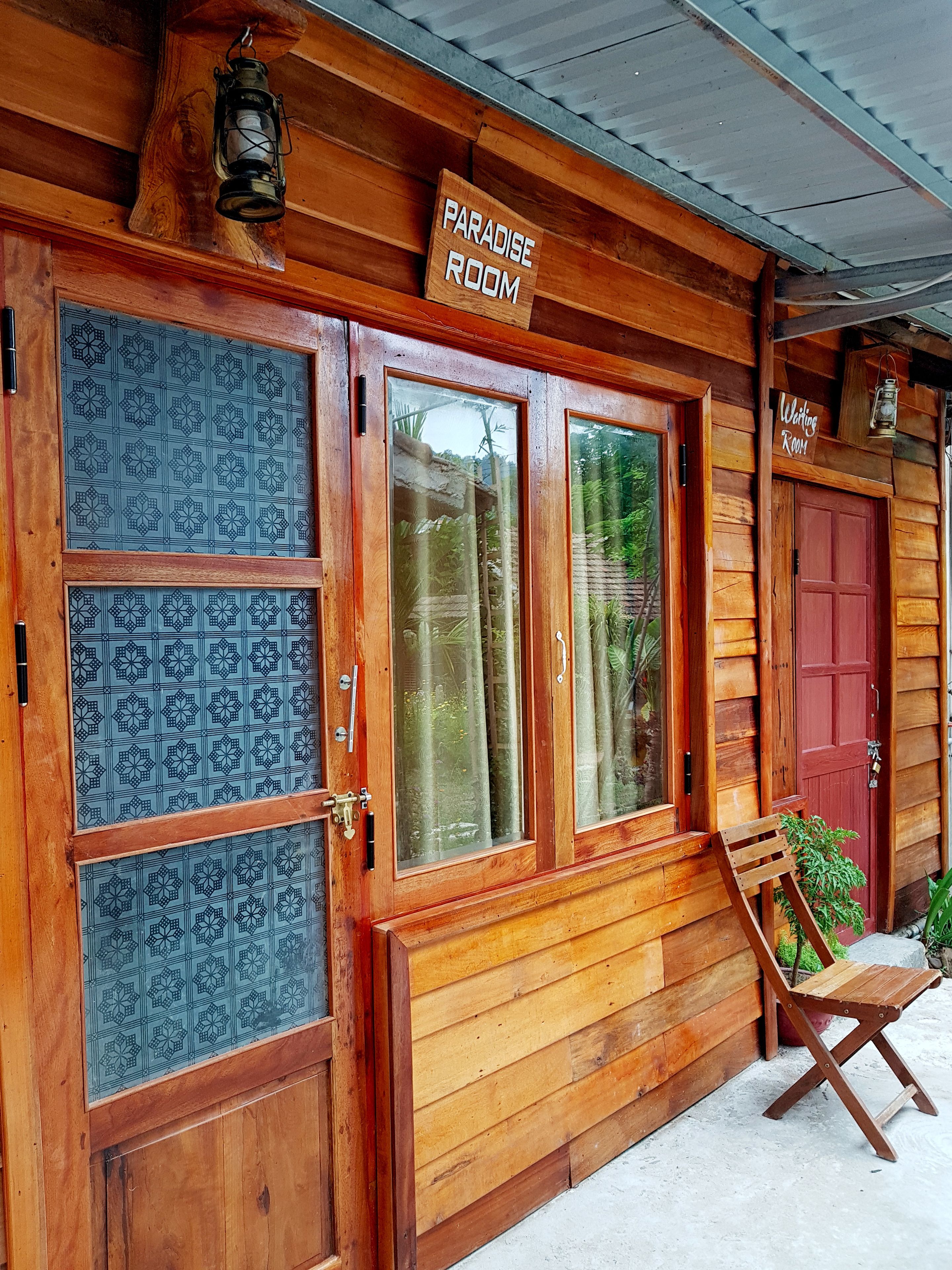 A wooden building with a sign reading "Paradise Room."