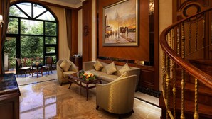 A spacious lobby with a grand chandelier, a large painting, and a staircase. - Chongqing Auwi Hotel (Chongqing)