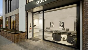 A modern hotel entrance with a large glass facade, a sign reading "QUEST", and a seating area with sofas and a coffee table inside. - Quest Maribyrnong (Maribyrnong)
