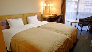 A hotel room with a large bed, a desk, a chair, and a small table. - Sawa Hotel (Fujikawaguchiko)