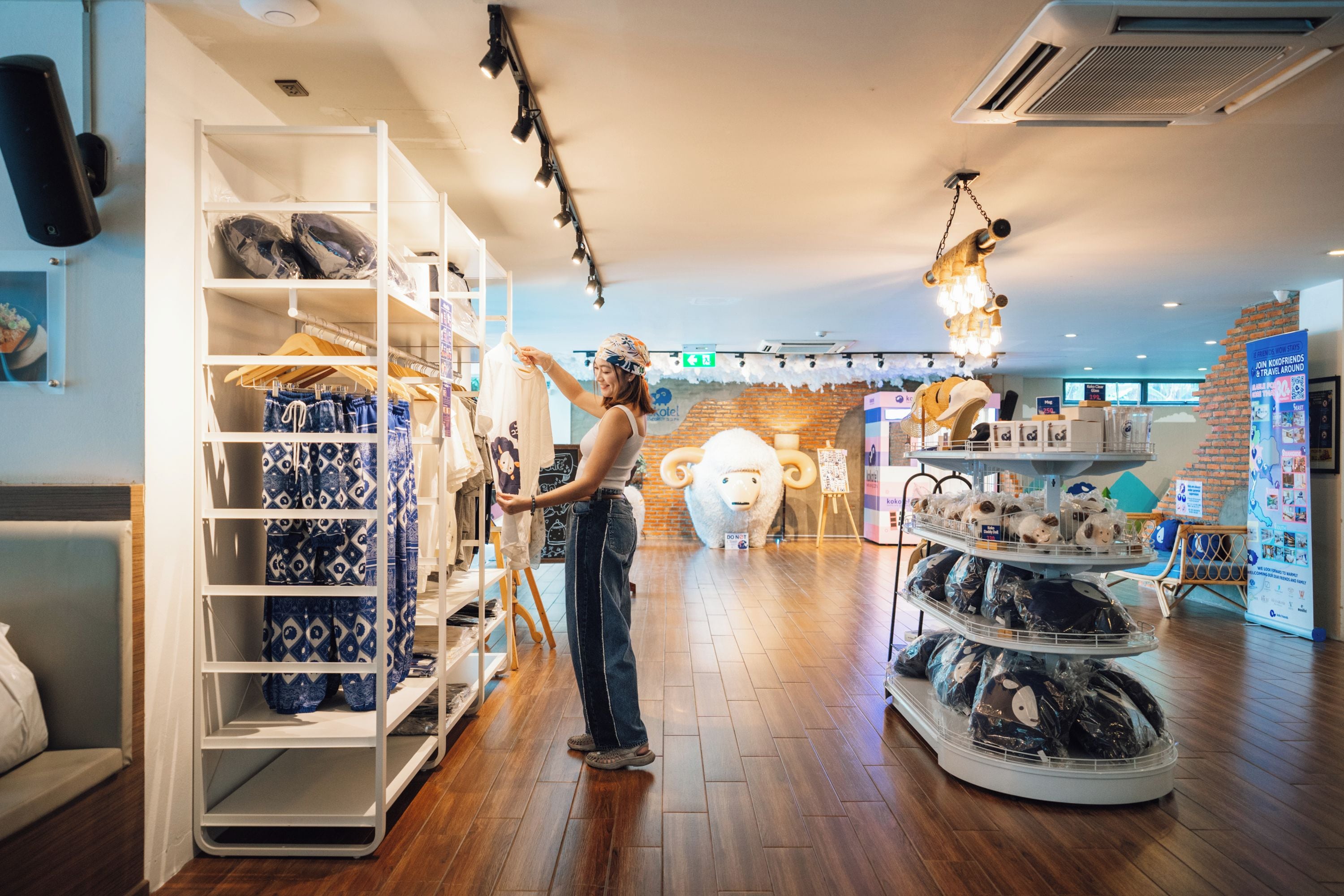 A retail store with clothing racks and a display of plush toys.