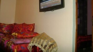 A room with a sofa and a television mounted on the wall. - Appartement 2 Chambre Ville Nouvelle Fes (Fes)