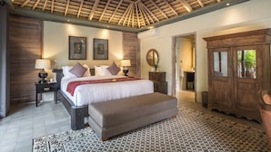 A bedroom with a large bed, bedside tables, a wooden wardrobe, and a patterned rug. - Jadine Bali Villa by Nagisa Bali (Canggu)