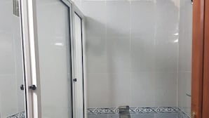 A small bathroom with a shower enclosure, a toilet, and a sink. - Apartment 3 Rooms city center Marmoucha (Fes)