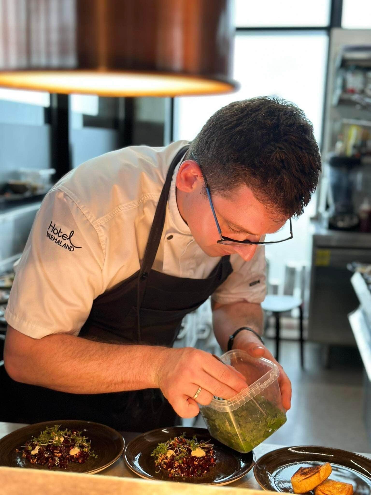 A chef preparing food in a professional kitchen.