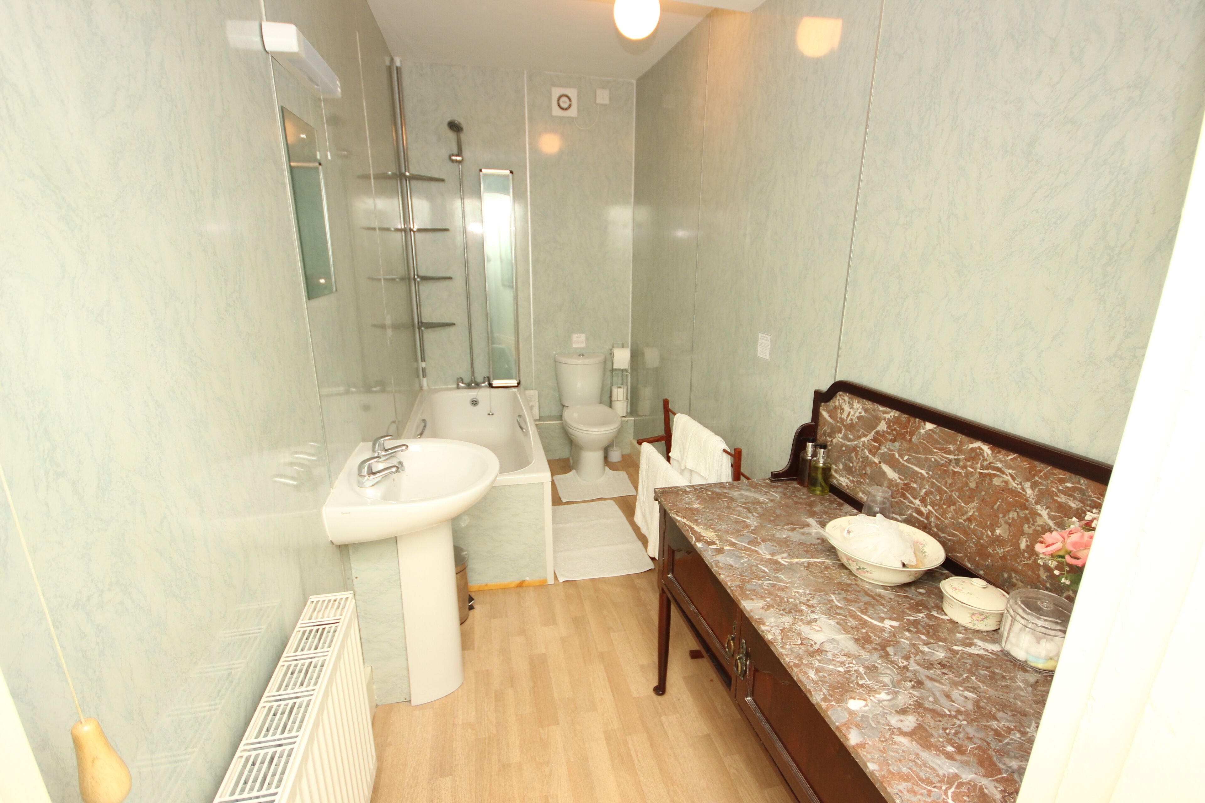 A bathroom with a sink, bathtub, toilet, and vanity.