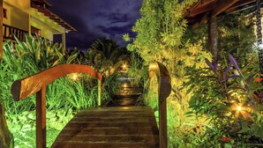 A wooden staircase leading to a building with a dark sky in the background. - Pousada Chamamé (Bonito)