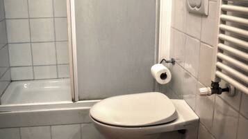 A bathroom with a toilet, bidet, and sink.