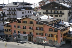 Un hotel de varios pisos con balcones, un bar y una boutique.