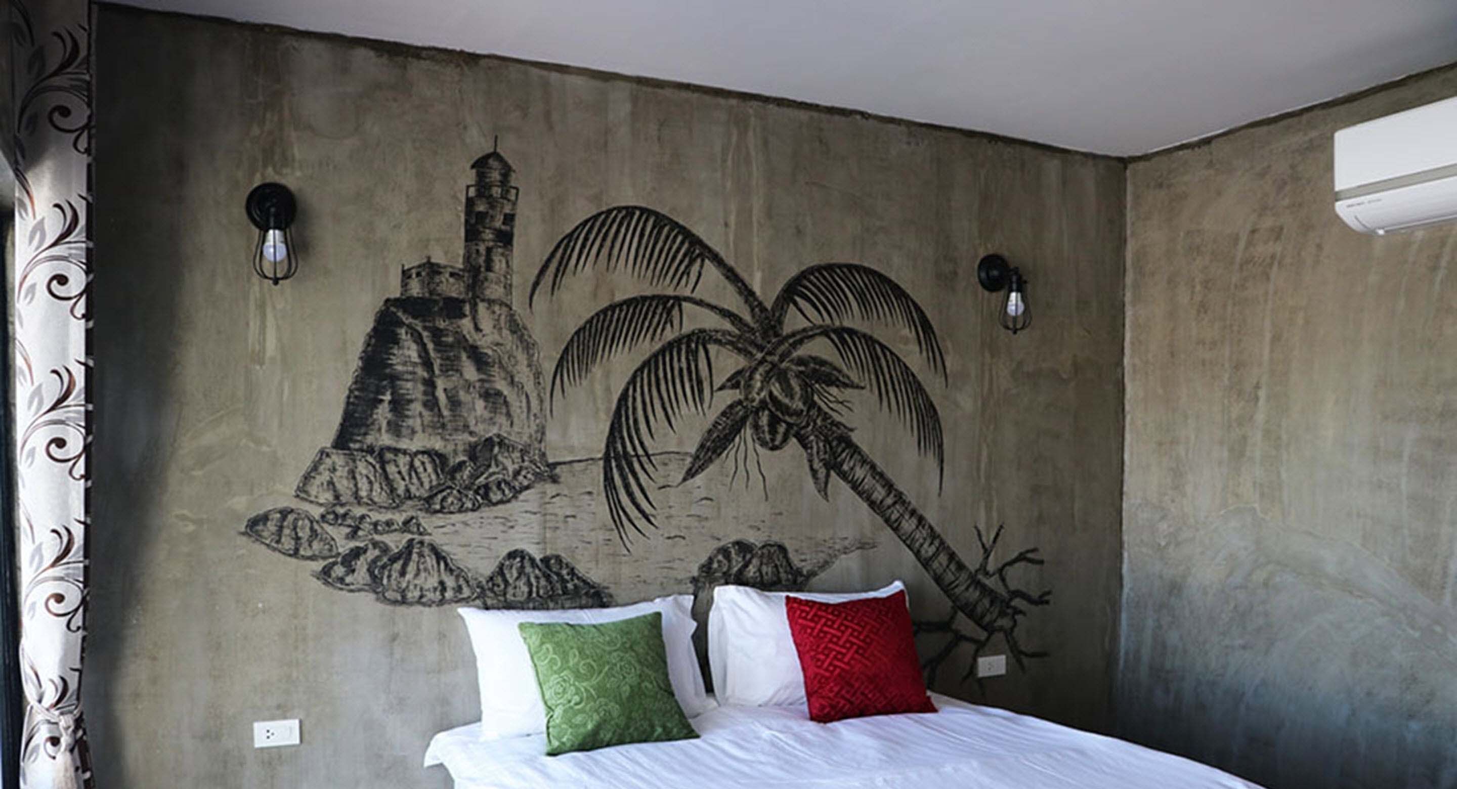 A bedroom with a mural of a mountain and palm trees, a bed with white bedding and two pillows, and a wall-mounted air conditioner.