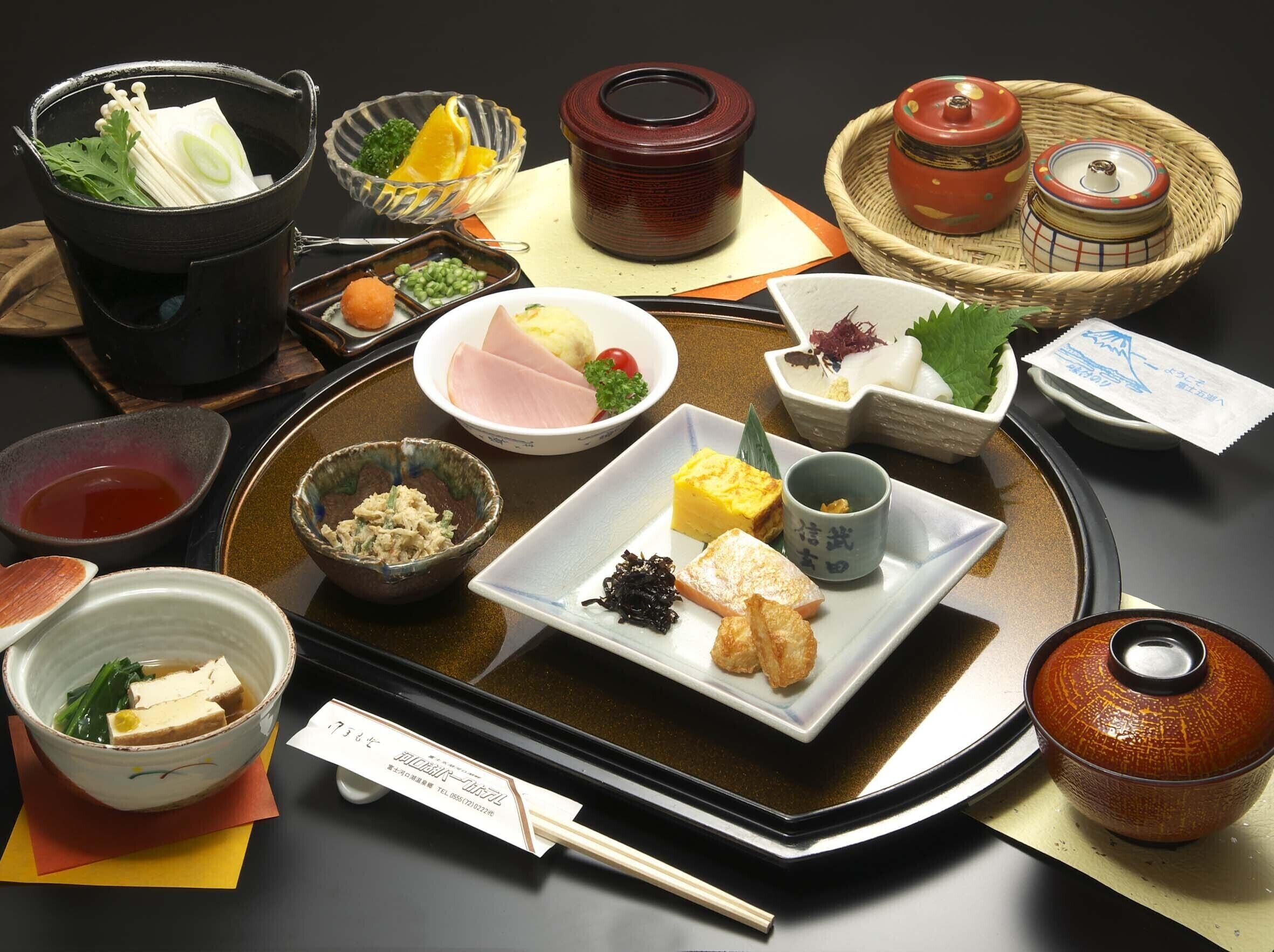 A traditional Japanese meal setup with various dishes and utensils on a tray.