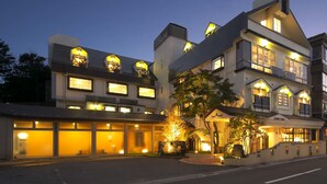 A hotel with multiple stories, large windows, and a well-lit facade. - Kawaguchiko Park Hotel (Fujikawaguchiko)