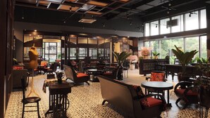 A spacious indoor area with multiple seating arrangements, including sofas and chairs, and large windows providing natural light. - Saigon Sirius (Ho Chi Minh City)