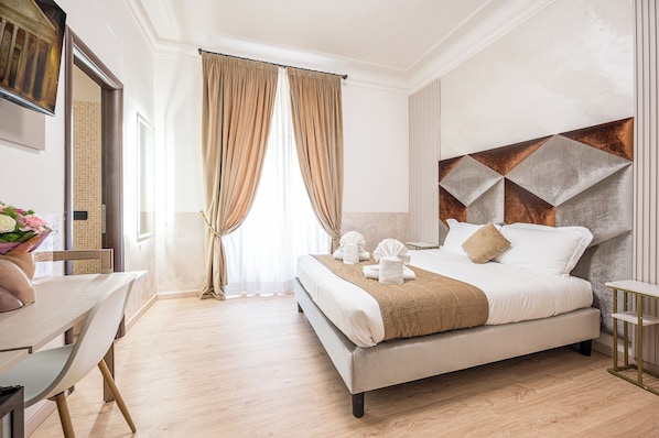 Una habitación de hotel con cama, escritorio y ventana con cortinas.