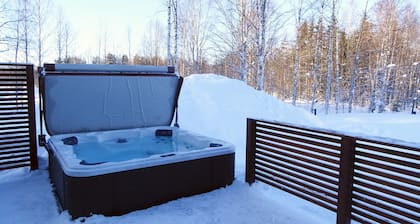 Modern Villa Lumikko with outdoor hot tub.