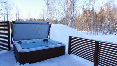 Modern Villa Lumikko with outdoor hot tub.