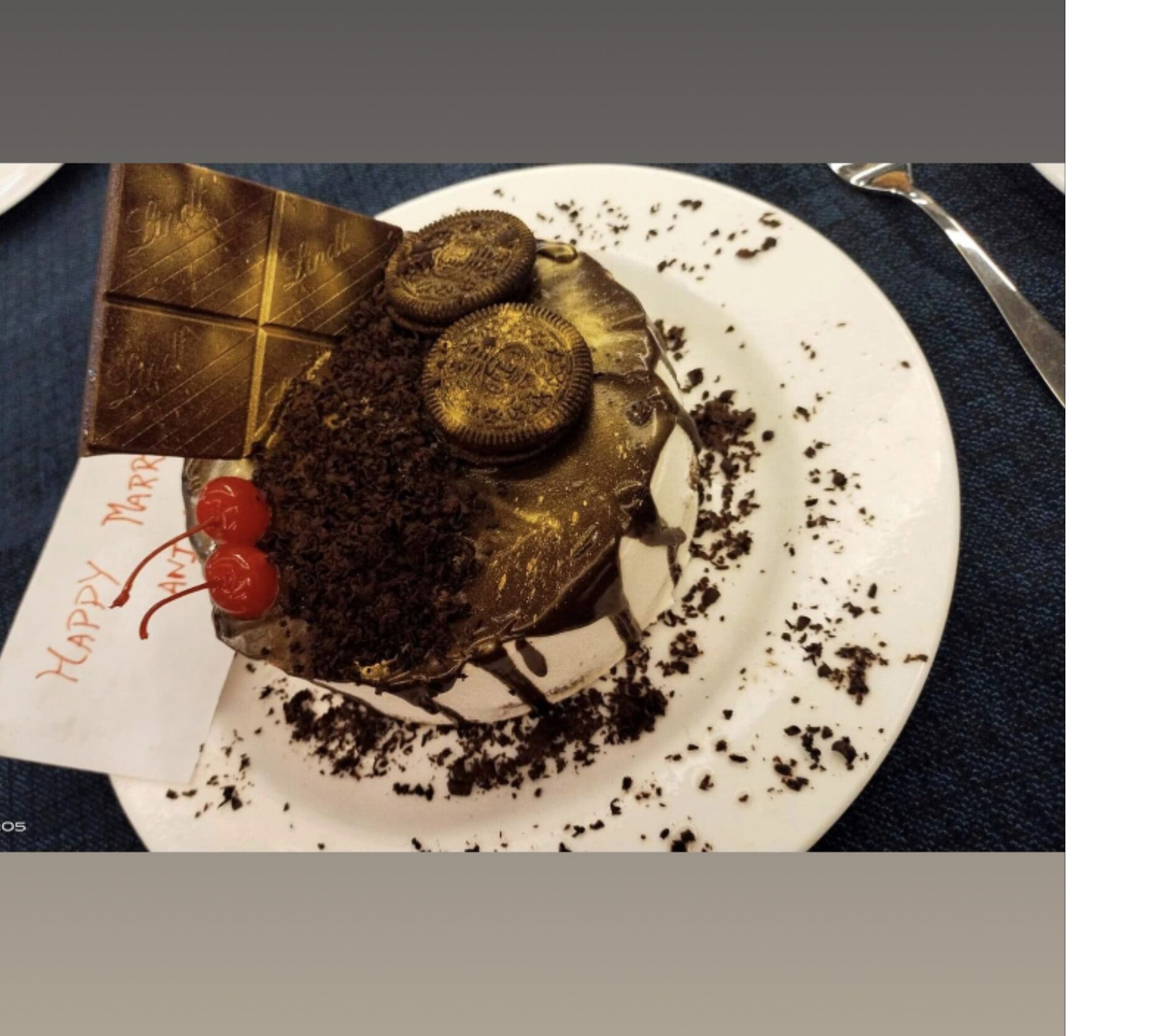 A dessert on a plate with a 'Happy Anniversary' note.