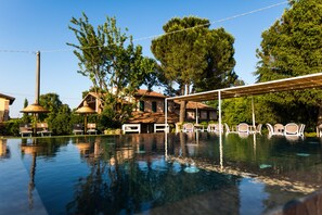 Seasonal outdoor pool, open 8:30 AM to 8:00 PM, pool umbrellas