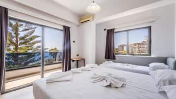 Triple Room, Sea View | Minibar, in-room safe, iron/ironing board, free WiFi