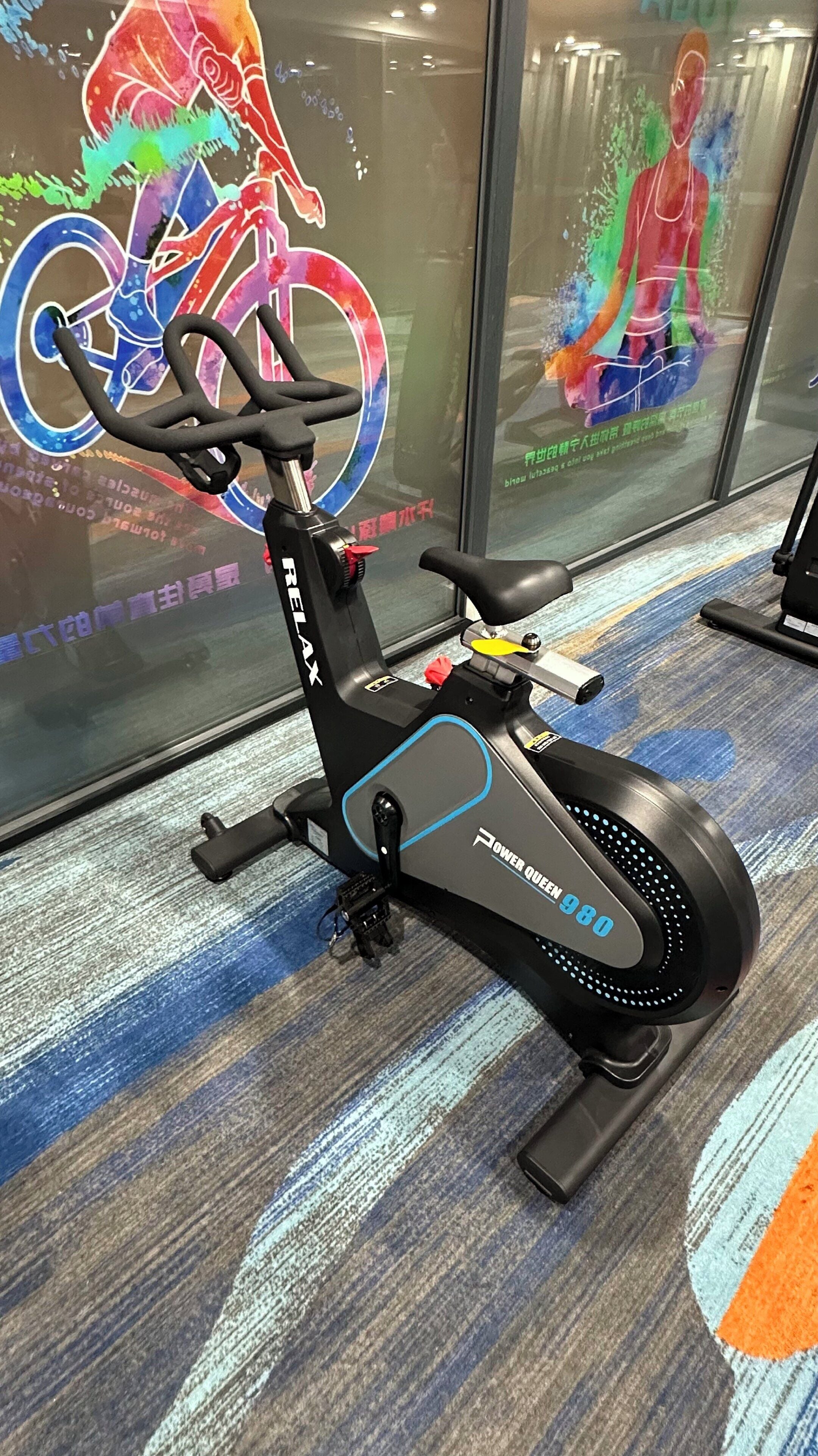 A stationary bike with a digital display and a handlebar.