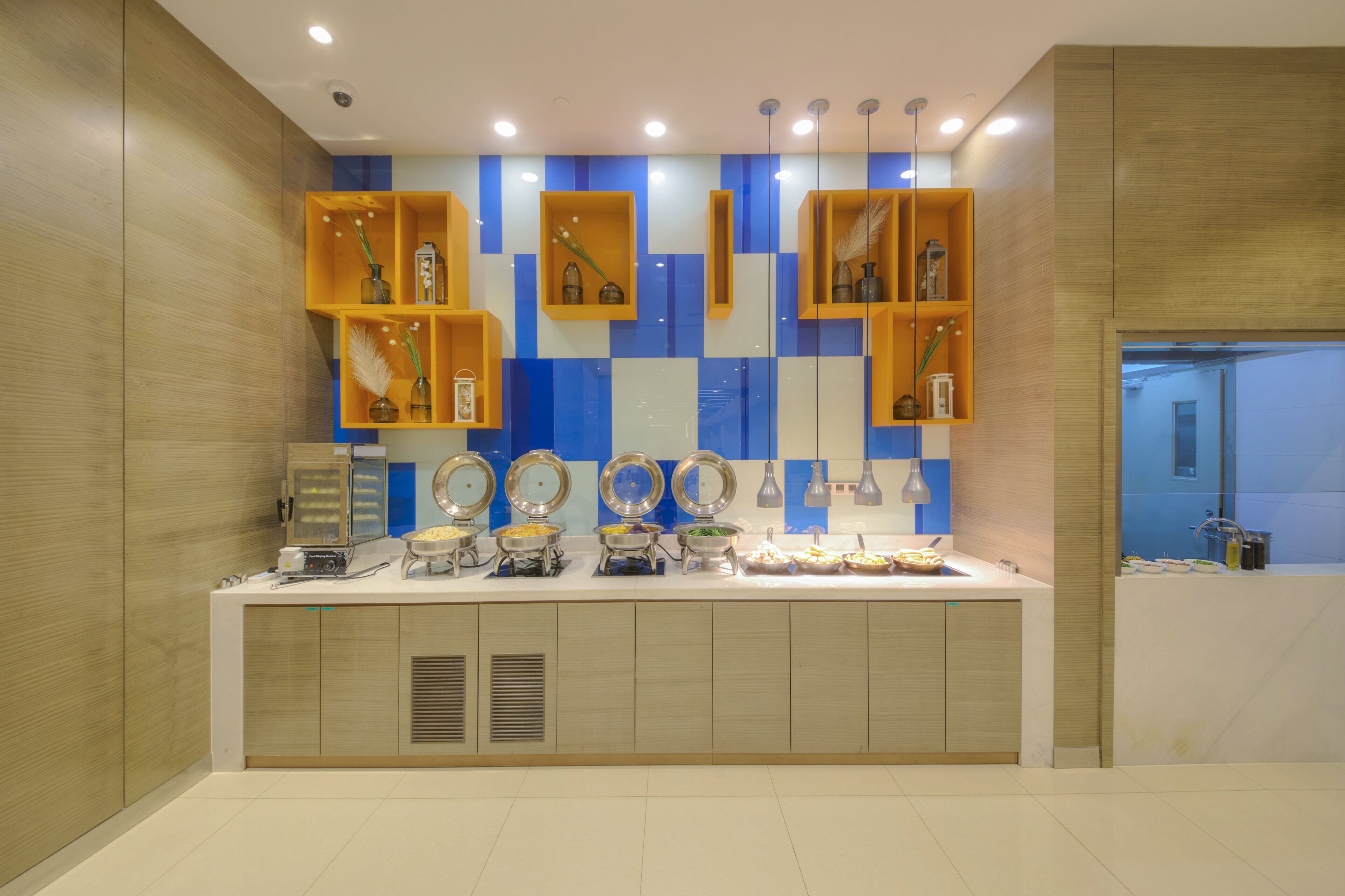 A modern kitchen with built-in appliances, a countertop with various food items, and a decorative backsplash.
