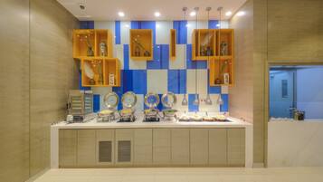 A modern kitchen with built-in appliances, a countertop with various food items, and a decorative backsplash.