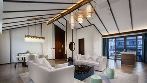 A modern living room with a sofa, coffee table, and unique lighting fixtures. - Wyndham Guilin Pingle (Guilin)