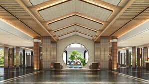 A spacious lobby with a high ceiling, a central circular window, and a traditional-style reception desk. - Wyndham Guilin Pingle (Guilin)