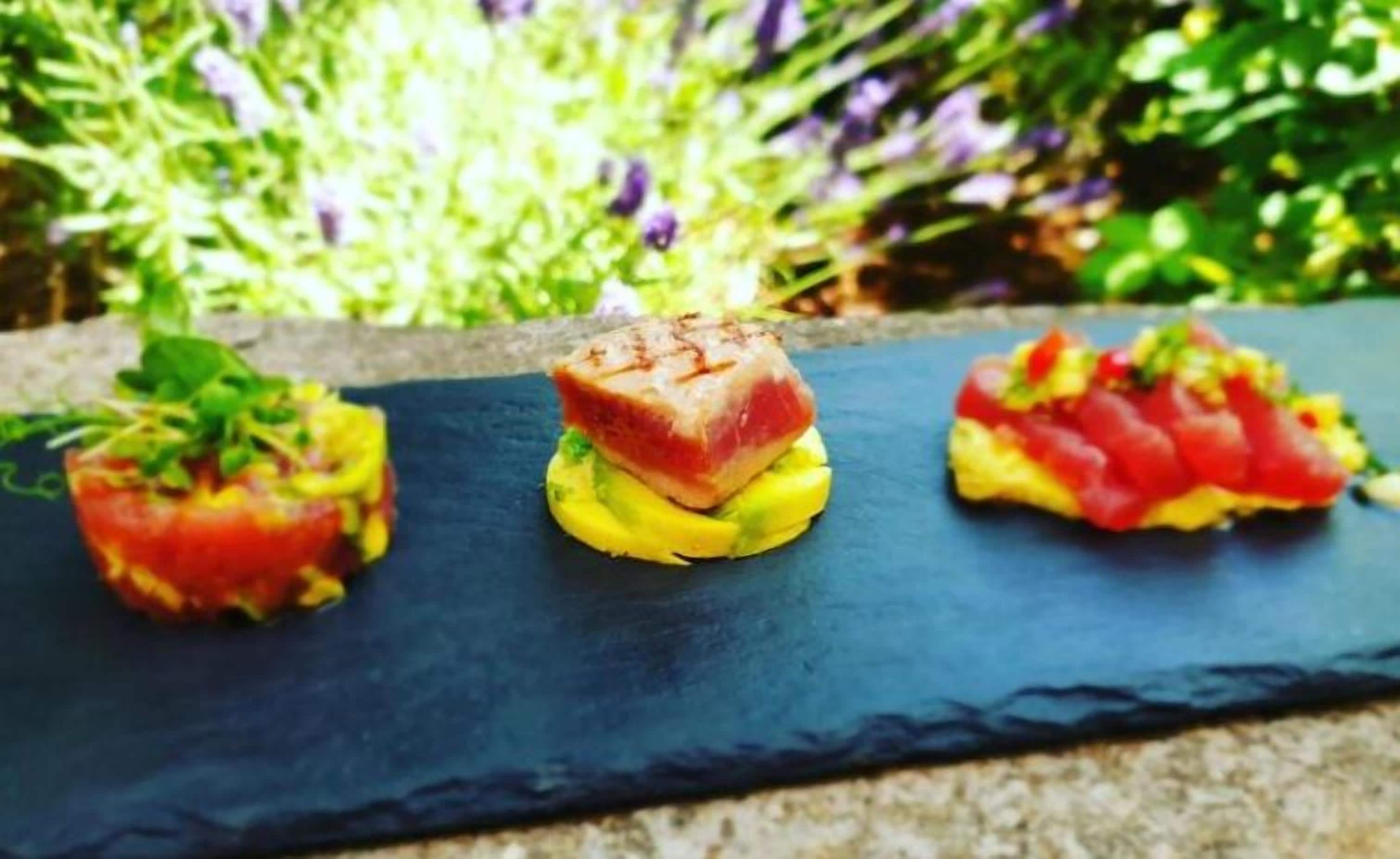 Three food items on a slate board.