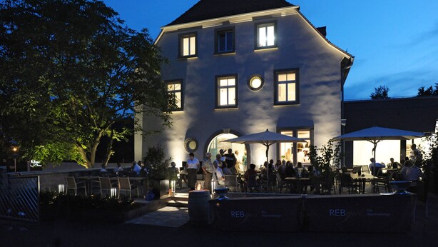 A large building with multiple windows and a balcony area with outdoor seating. - Rebgut - Die Weinherberge (Lauda)