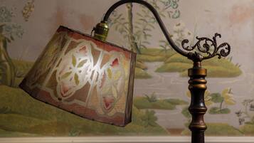 A lamp with a patterned shade and a decorative metal stand.