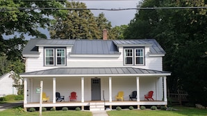 A two-story house with a porch, a chimney, and a mailbox. - Manchester Walking distance to all shops and restaurants quick ride/lakes |hikes (manchester center)
