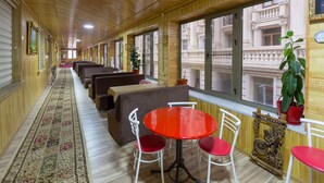 A corridor with seating areas, large windows, and a patterned carpet. - Renessans Hotel Baku (Baku)