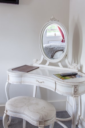 A white vanity with a mirror, a book, and a remote control on it. - The Wychwood Inn (Chipping Norton)