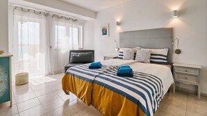 A bedroom with a bed, bedside tables, a nightstand, a lamp, a window with curtains, and a wall-mounted picture. - TOP - APARTMENT VISTA PRAIA WITH FANTASTIC SEA VIEWS (Armacao de Pera)