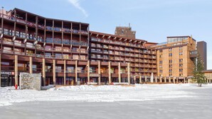 A multi-story hotel with balconies, a stone facade, and a restaurant named "RESTAURANT BAR KILIMANJARO".