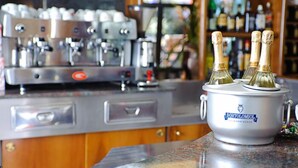 Una cocina con cafetera y una olla grande marcada con el nombre 'Bortolomol' sobre una encimera.