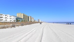 A beach with buildings in the background.