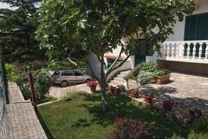 Enjoy a serene garden setting with a driveway and a charming home with a simple, functional design.