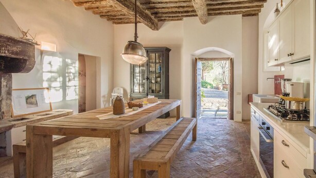 A rustic kitchen with wooden tables, a hanging light, and a view to the outside. - Awesome home in Lari -PI- (Lari -PI-)