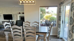 A dining area with a table and chairs, a television, and a fireplace. - Sports Village Cliffside Getaway/3 bed/2 bath w/View located in St George, UT (St George)
