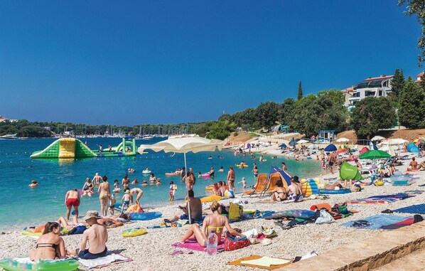 Enjoy water activities and relaxation on this well-equipped beach with lounge chairs, umbrellas, and inflatables.