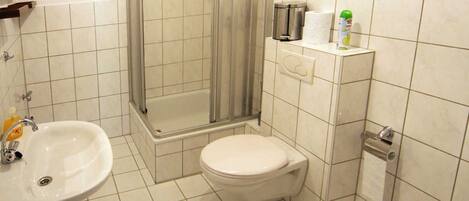 Ein Badezimmer mit Waschbecken, Toilette und Dusche.