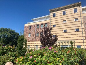 A multi-story building with a brick facade and a flat roof.