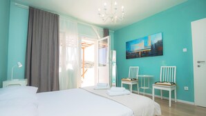 A bedroom with a bed, two chairs, a painting, and a chandelier. - 3 bedroom awesome apartment in Rogoznica (Rogoznica)