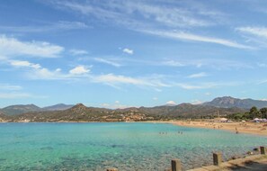 A coastal beach with clear turquoise water, a sandy shore, and a backdrop of mountains. - Awesome home in Calcatoggio (Calcatoggio)